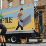 Moving crew unloading a truck on a city street, illustrating professional movers at work. Photo by Metropolis Moving on Unsplash.