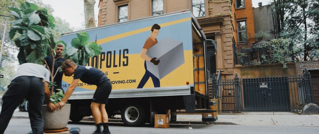 Professional movers loading furniture onto a moving truck on a city street in Beacon NY