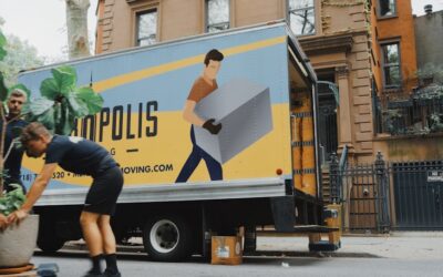 Professional movers loading furniture onto a moving truck on a city street in Beacon NY