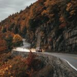Winding scenic road through autumn foliage in the Hudson Valley, New York — representing local moves across Dutchess County. Photo by Clay Banks.