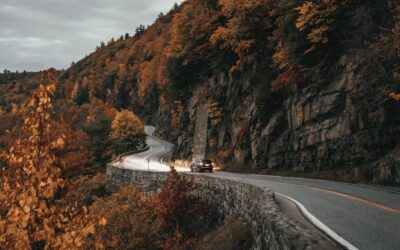 Winding scenic road through autumn foliage in the Hudson Valley, New York — representing local moves across Dutchess County. Photo by Clay Banks.