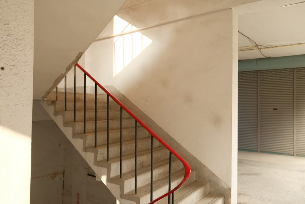 Winding interior staircase in an older apartment building, the kind that adds time and cost to a local move