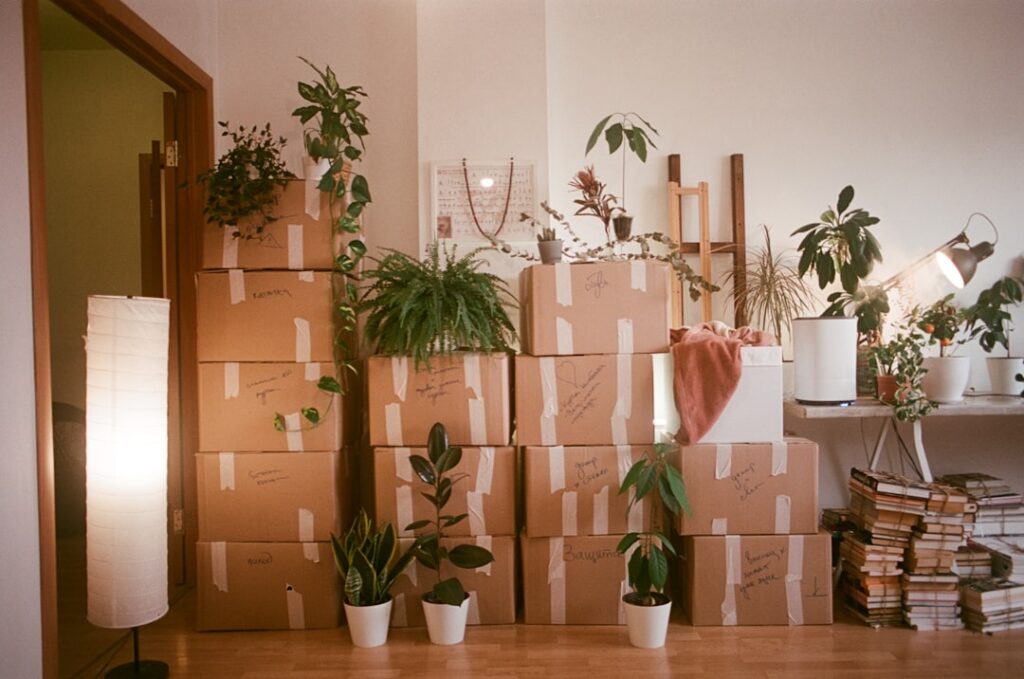Stacked cardboard moving boxes packed and ready in a living room before a local move
