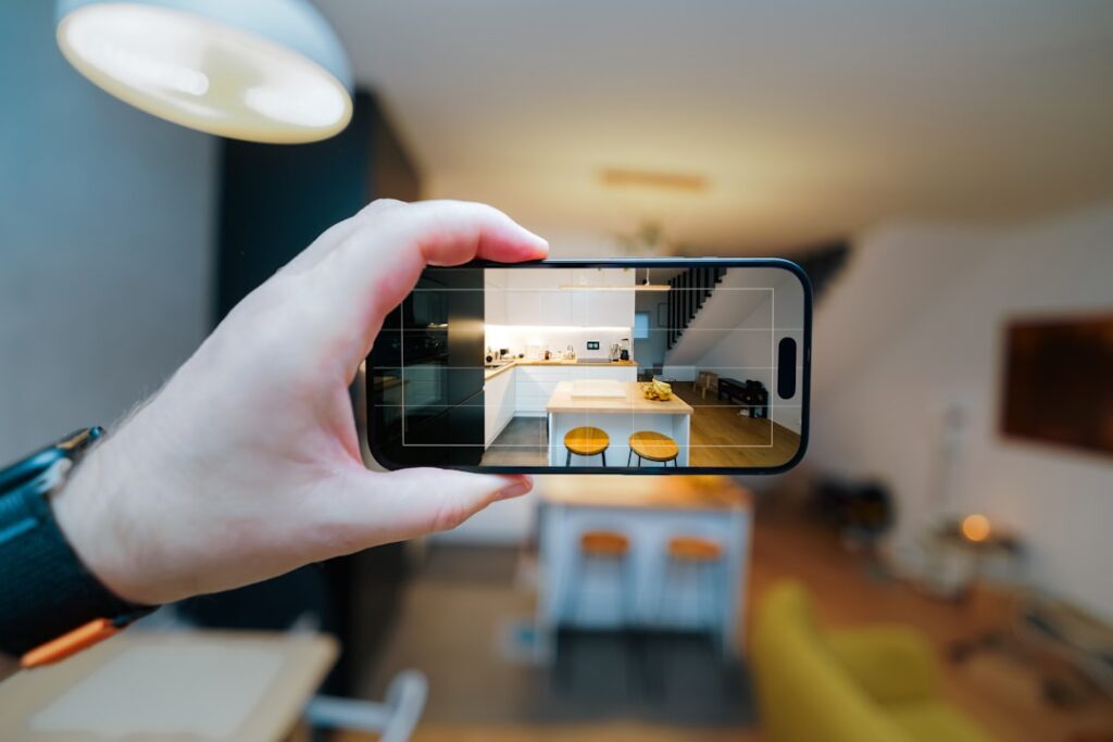 Person holding a smartphone scanning an apartment interior to get an AI-powered moving quote