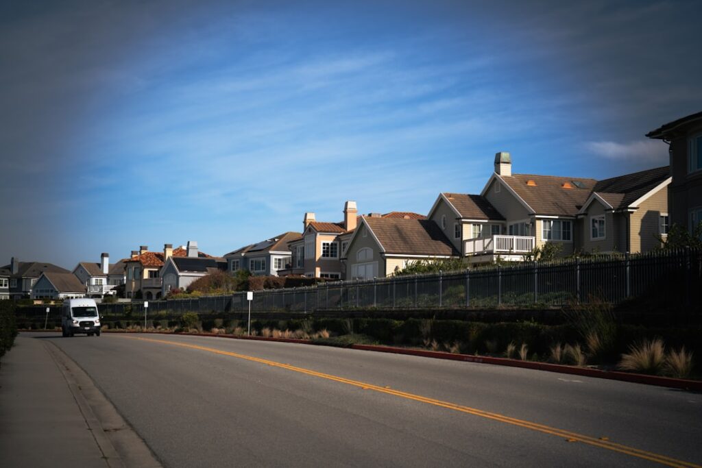 Suburban residential street with houses and a van, representing neighborhoods across Dutchess County towns like Fishkill and Wappingers Falls